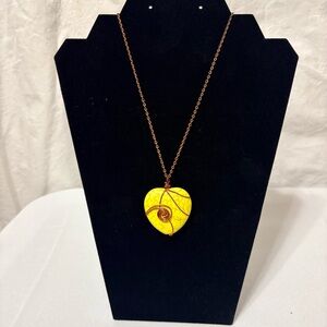 yellow stone heart pendant necklace with a copper-tone wire wrap and chain.